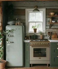 a kitchen with green cabinets and an old fashioned stove