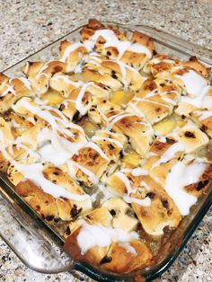 a casserole dish with bananas and cream drizzled on top