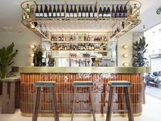 a bar with three stools in front of it