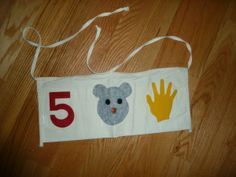 a white bag with an image of a koala and handprints on it