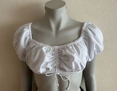 "White Dirndl Blouse Crop Dirndl Top Vintage Snow White Blouse Cropped Blouse Women Short Sleeve Trachten Tyrolean Blouse Austrian Top  Label size: 38 Measurements (lying flat): Sleeve: 8\"/ 20 cm Pit to pit: 16\"/ 40.5 cm Length: 12\"/ 30 cm Condition: Great Vintage Condition Material: 50%cotton, 50%polyester Please check measurements to insure a proper fit. Remember to allow yourself some extra room for movement. You can compare these with something from your closet that fits you well. If you Fitted Short Sleeve Peasant Top For Daywear, Fitted Peasant Style Short Sleeve Blouse, Fitted Short Sleeve Peasant Blouse, Fitted Peasant Blouse With Short Sleeves, White Dirndl, Vintage Snow White, Womens Waistcoat, Womens Black Vest, Blouse Crop