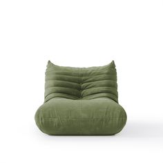 a green pillow sitting on top of a white floor