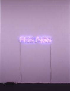 a neon sign that reads feelings on the side of a wall with wires attached to it