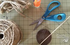 scissors, twine and other craft supplies on a cutting board