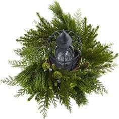 a lantern surrounded by evergreen branches and pine cones