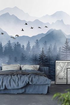 a bedroom with mountains and birds painted on the wall