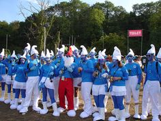 a group of people dressed in blue and white standing next to each other on a field