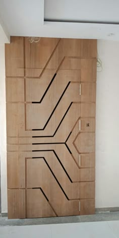 a wooden door with lines drawn on it in front of a white wall and floor