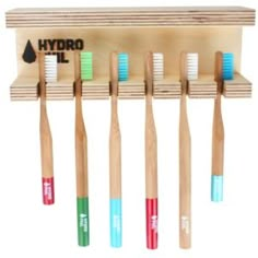 several toothbrushes are lined up on a wooden shelf with hydro oil labels and the word hydro