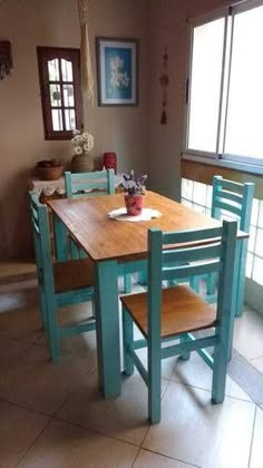 a kitchen table with four chairs around it