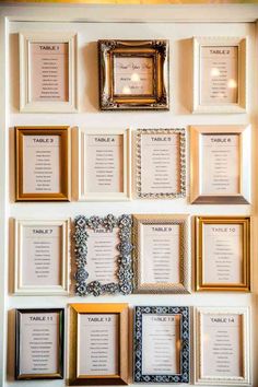 a wall with many different frames and place cards on it's side, all lined up against the wall