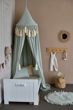 a child's bedroom with a canopy bed and rugs on the floor in front of it