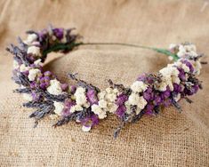 a headband made out of dried flowers on top of burlocked fabric