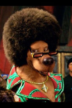 a man in an afro wig and glasses standing next to other people