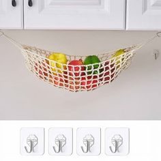 there are four hooks on the wall to hold fruit and vegetables in a hammock