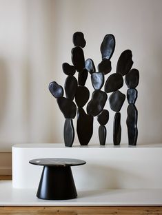 a black sculpture sitting on top of a white table