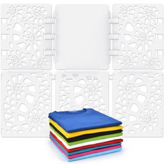 four different colors of cloths are stacked on top of each other in front of a white background