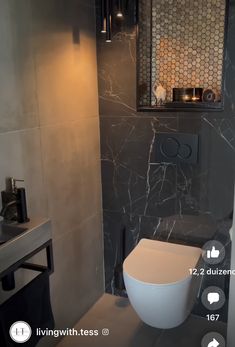 the bathroom is decorated in black and white marble