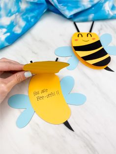 someone is cutting out some paper to make a bee craft for their child's room