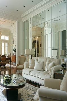 Luxurious living room with paneled mirror walls creating a spacious and elegant atmosphere. Wall Mirror Modern Design, Mirror Wall Apartment, Mirrored Walls Living Room, Mirror Wall Design Ideas, Mirror Wall Decor Living Room Modern, Living Room Mirror Wall, Luxury Mirror Wall, Wall Mirror Ideas Living Room, Mirror Wall Decor Living Room