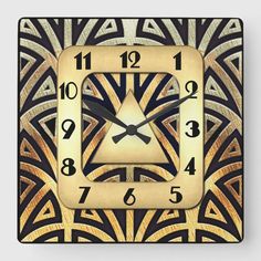 a square clock with an art deco design on the front and sides, in gold and black