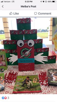 a table topped with lots of books and candy sticks in front of a sign that says melba's post