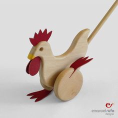 a wooden toy with a red and yellow rooster on it