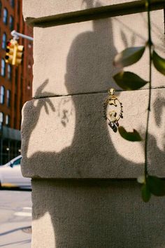 the shadow of a person's head on a wall next to a street light