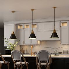 a kitchen with white cabinets and black counter tops, four chairs are in front of the island