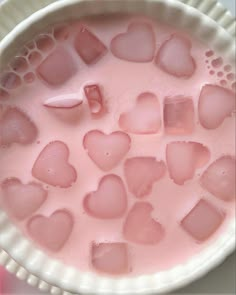 a bowl filled with pink liquid and lots of hearts