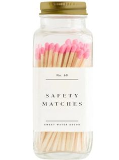 pink and white matches in a glass jar on a white background with the words safety matches written