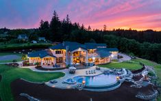 an aerial view of a large home with a pool and hot tub in the front yard