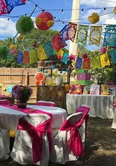 an outdoor party with colorful decorations and tables