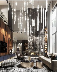 an elegant living room with modern furniture and chandelier hanging from the ceiling above