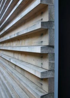 the side of a building with wooden slats on it