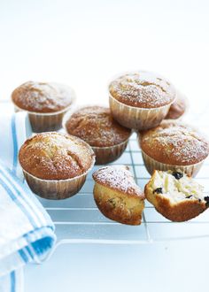 muffins on a cooling rack with powdered sugar