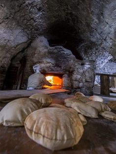 some bread is laying on the ground in front of an oven with a light at the end