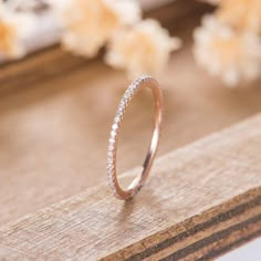 a diamond ring sitting on top of a wooden table