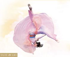 a woman in pink is performing aerial acrobatics