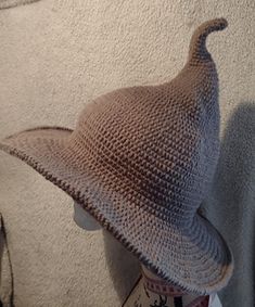 a crocheted hat sitting on top of a mannequin's head