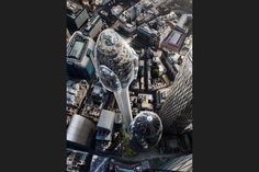 an aerial view of the city with skyscrapers and other buildings in the foreground