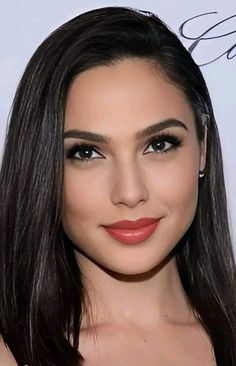 a woman with long dark hair and brown eyeshadow wearing red lipstick, posing for the camera