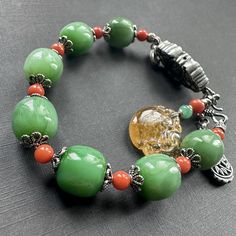 This uniquely designed bracelet combines the high quality green nephrite jade and 925 solid silver charms.  The bracelet contains 7 natural green nephrite jade beads. They are untreated, in medium green color. Those beads has the gorgeous glowing to bring the calmness to the eyes. They also have very high clarity even though it's common for natural green nephrite jade to have dark spots/lines  and cloud inclusions inside the stone. Those beads are measured approximately 12.5mm x 12mm in dimension.  The spacer beads are natural Nanhong red agate beads. And the carved pendant charm is made of yellow tourmaline.  All metal spacers and charms are customer designed and made of  925 solid silver. The length of the bracelet is 21cm (8"), can be extended to 23cm (9") with the extension chain inclu Carved Pendant, Precious Beads, Nephrite Jade, Silver Charm Bracelet, Red Agate, Jade Beads, Agate Beads, Natural Beads, Bracelet Designs