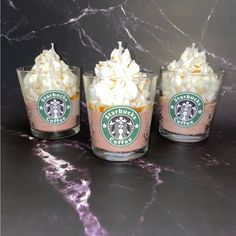 three shot glasses filled with whipped cream and starbucks coffee