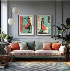 a living room with two paintings on the wall and a couch in front of it