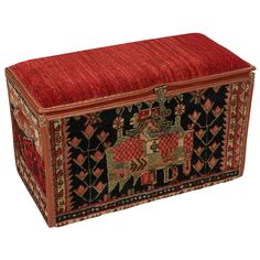 an old trunk is decorated with red and black designs on the sides, along with a decorative pattern