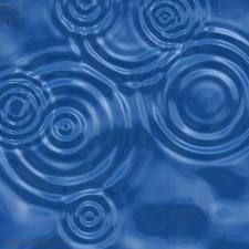 an image of water ripples and circles in the blue sky with clouds behind them