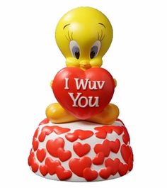 a yellow rubber duck holding a red heart with the words i wuv you on it