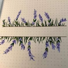 some purple flowers are on the side of a white board