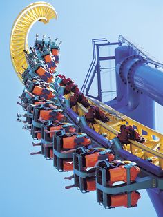 an amusement park ride with people on it's roller coasters in the sky